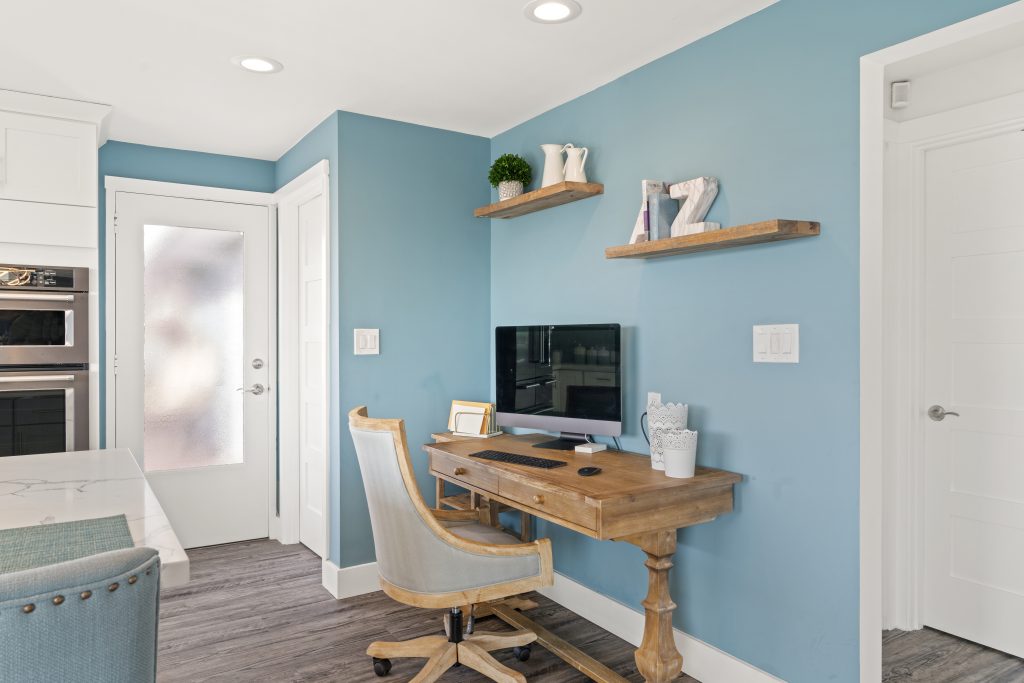Picture of a kitchen with a desk neatly in one corner